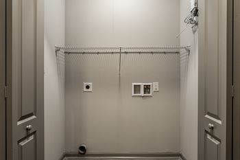 A white room with a shower in it and a white door